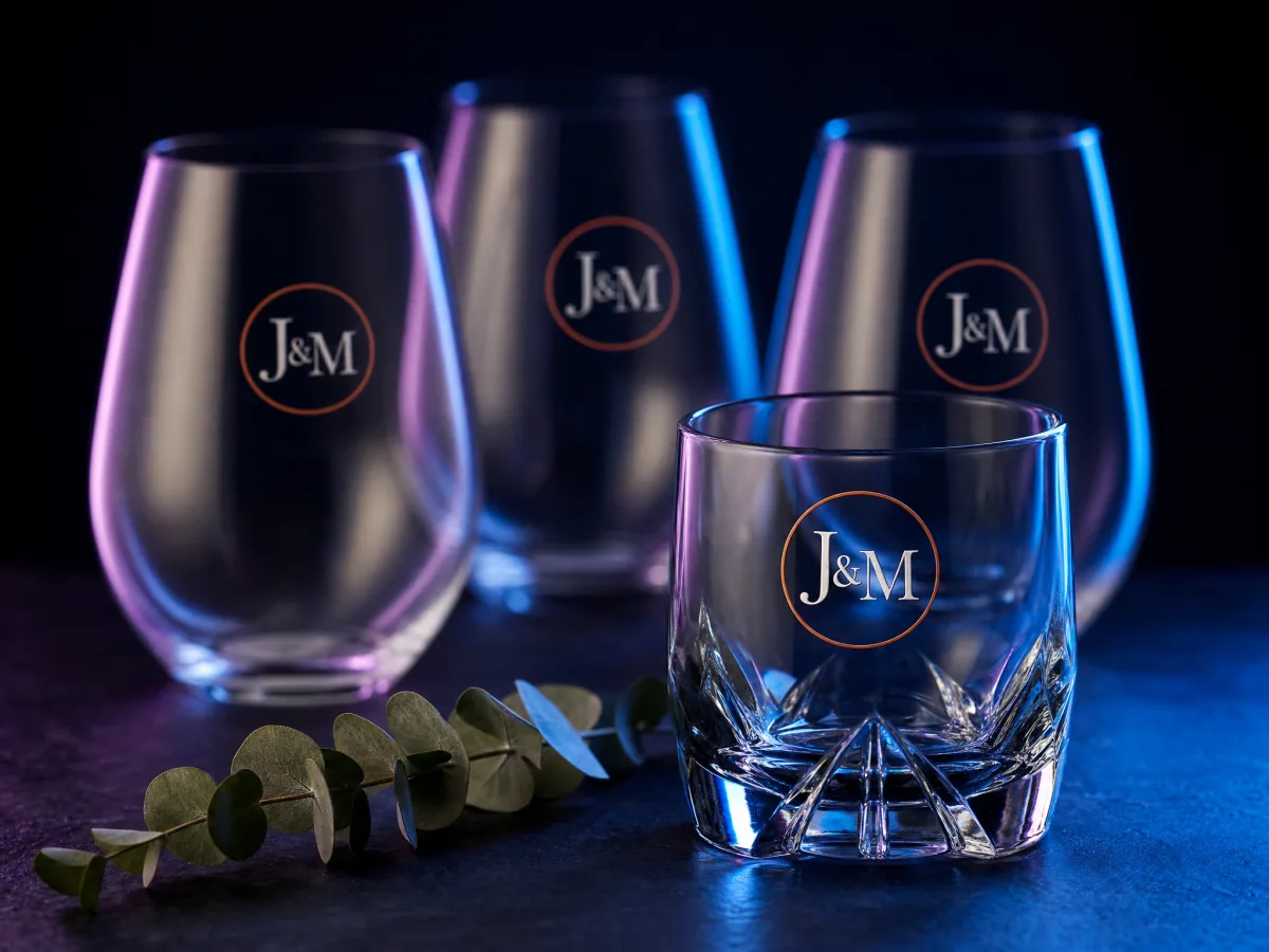 Stemless wine glasses with a small monogram applied to the smooth side, styled as wedding favors