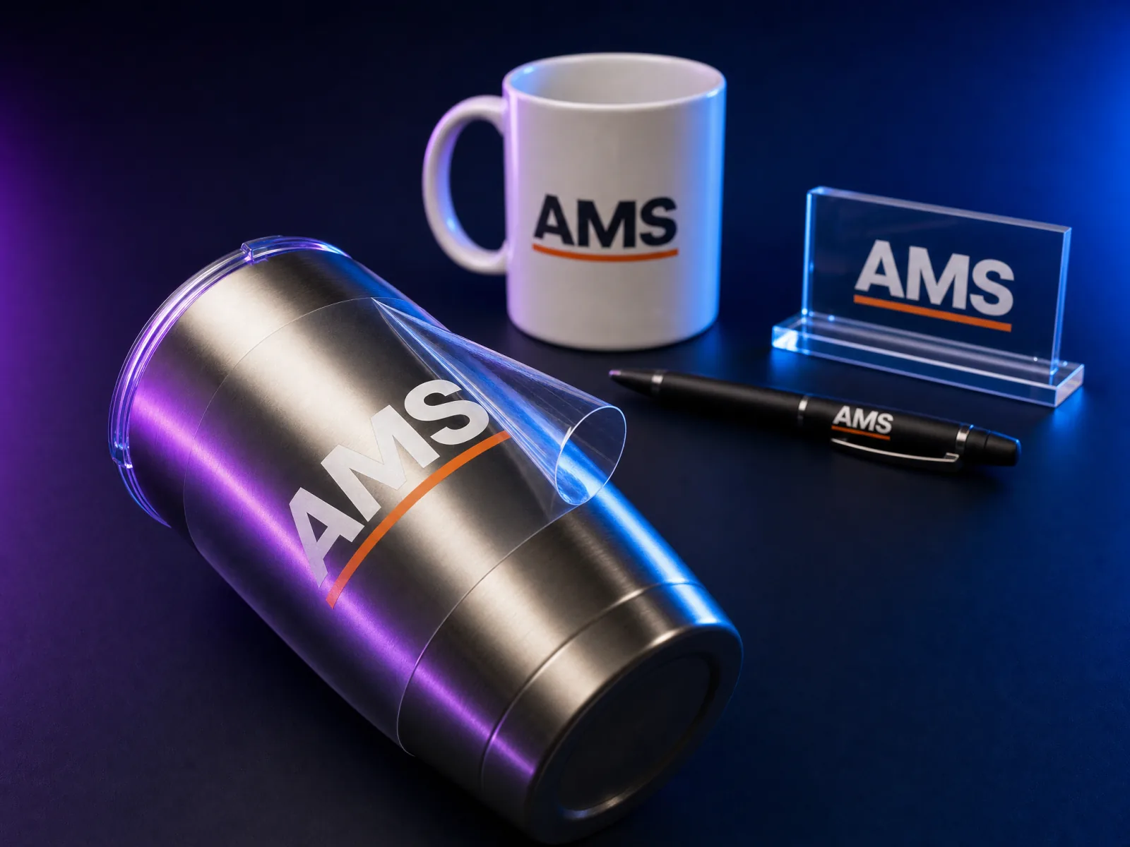 A UV DTF welcome kit: a mug, a pen, and an acrylic desk sign sharing one logo, with a tumbler's carrier film peeling away