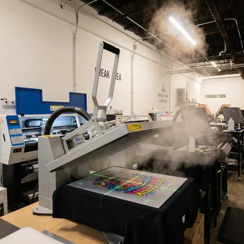 DTF heat press pressing a custom design onto a shirt at AMS