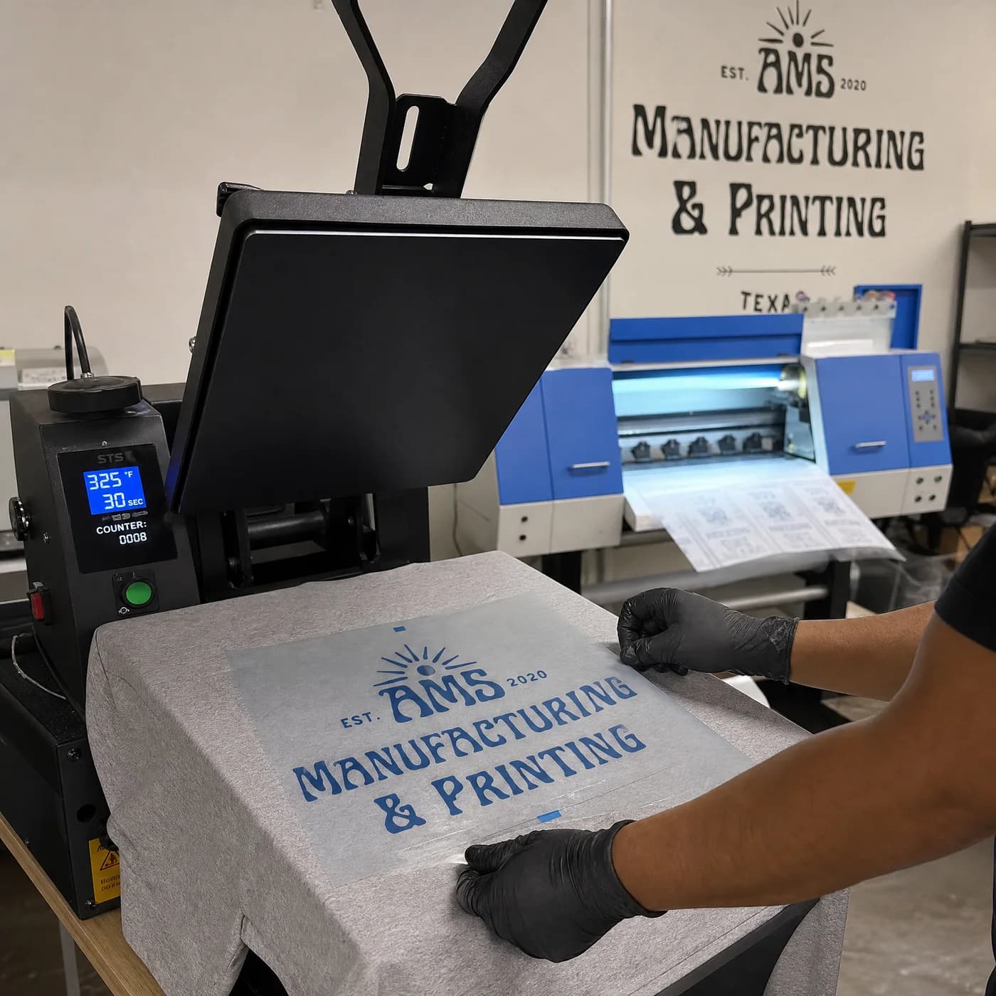 Shop context image showing heat press setup for a dry blend shirt order