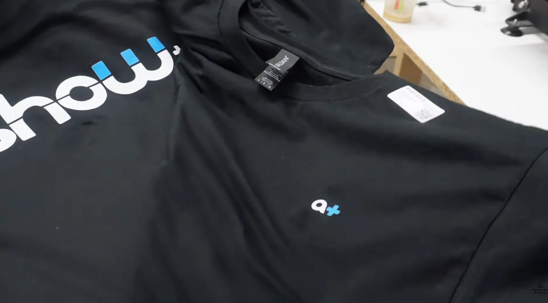 Two black Gildan DryBlend shirts showing a large back print, small left chest print, and visible DryBlend tag